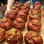 Beignets filled with brioche custard & glazed with strawberry, caramel & pistachio from Fortitude Bakehouse